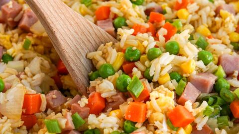 ham fried rice in a skillet with wooden spoon