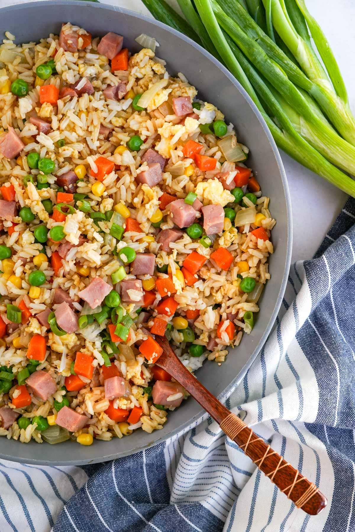 ham fried rice in a skillet with wood spoon