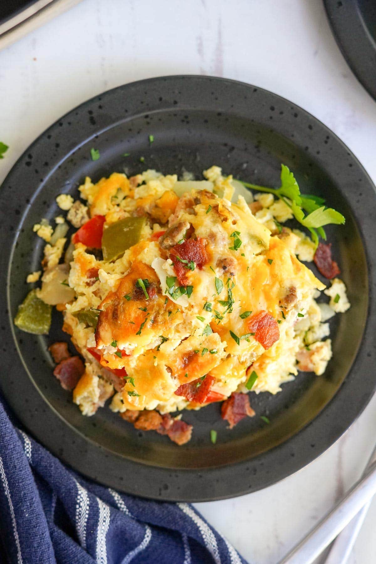 overhead image of breakfast casserole on a black plate