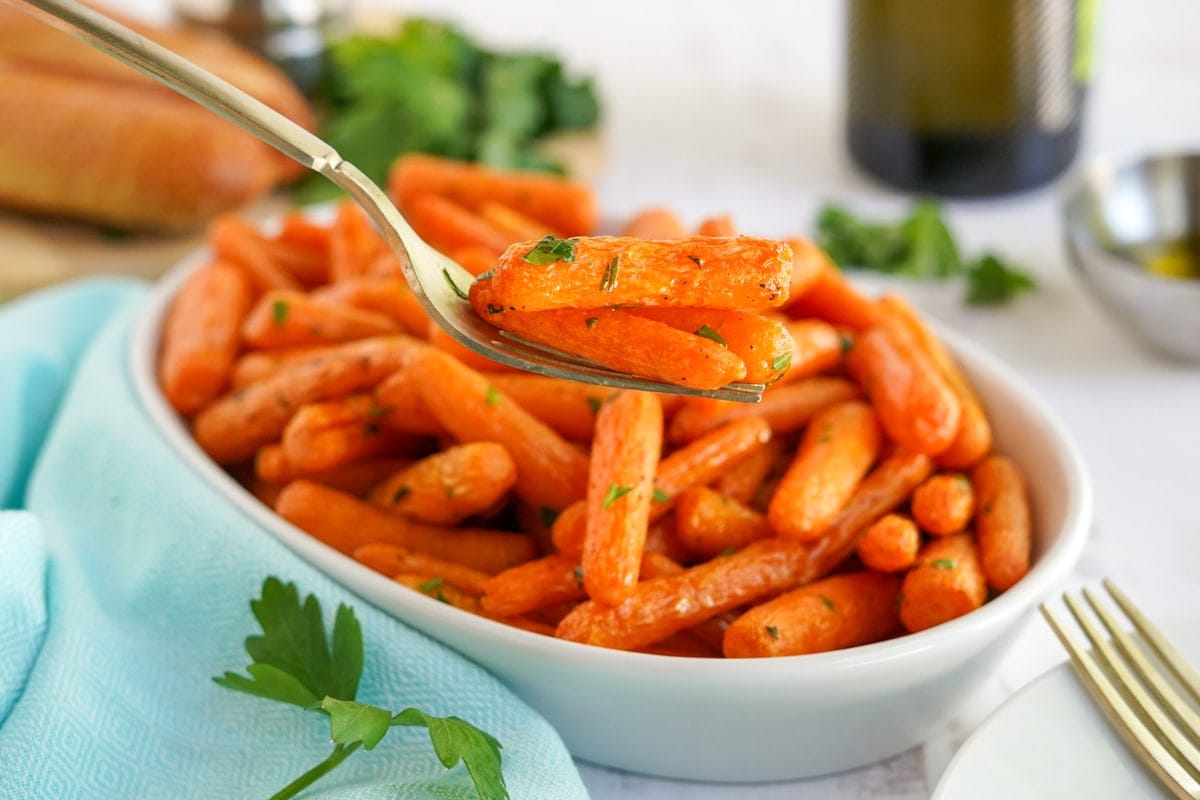air fryer cooked carrots, spoon white dish