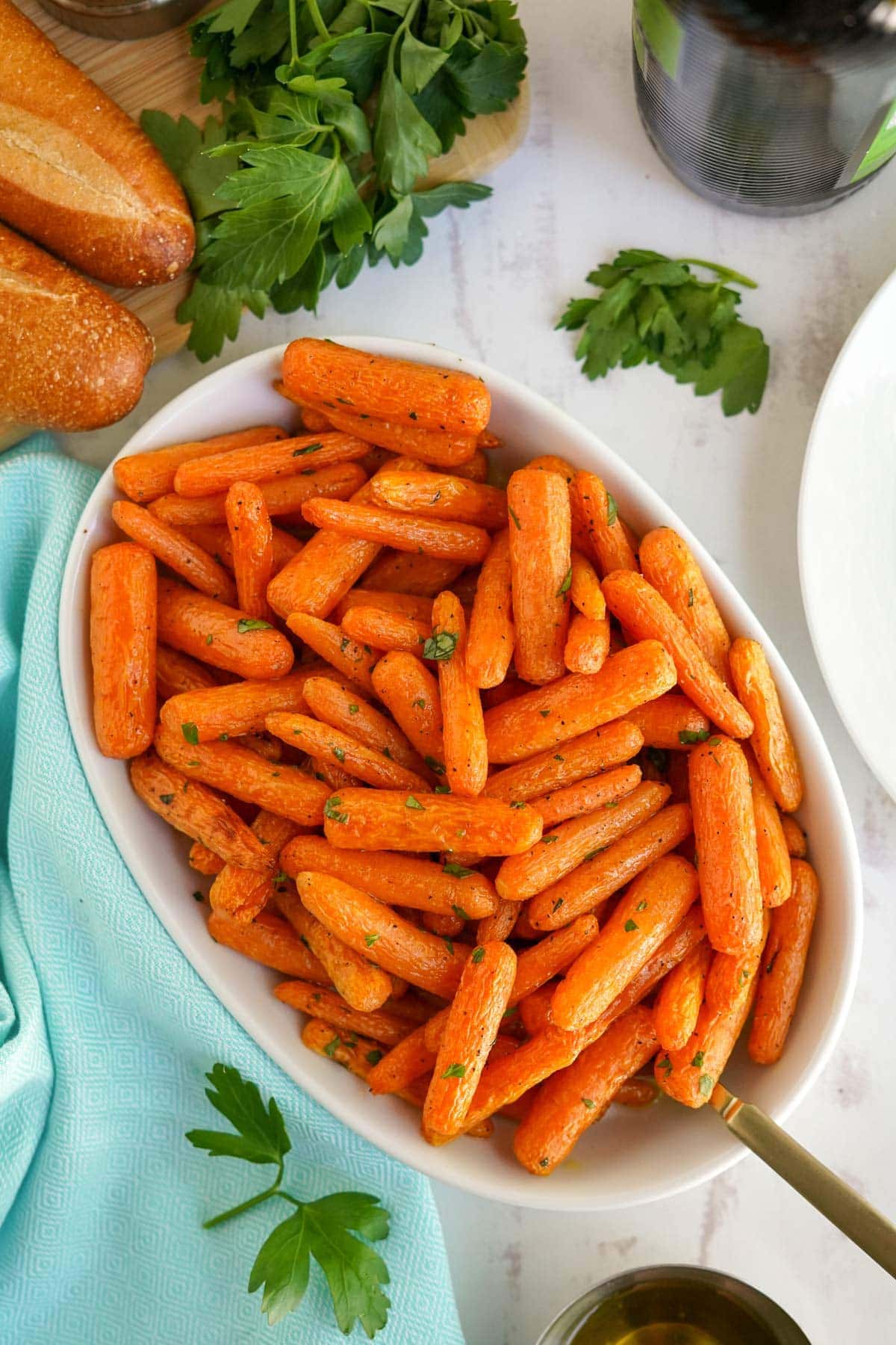 baby carrots in a white dish with a spoon