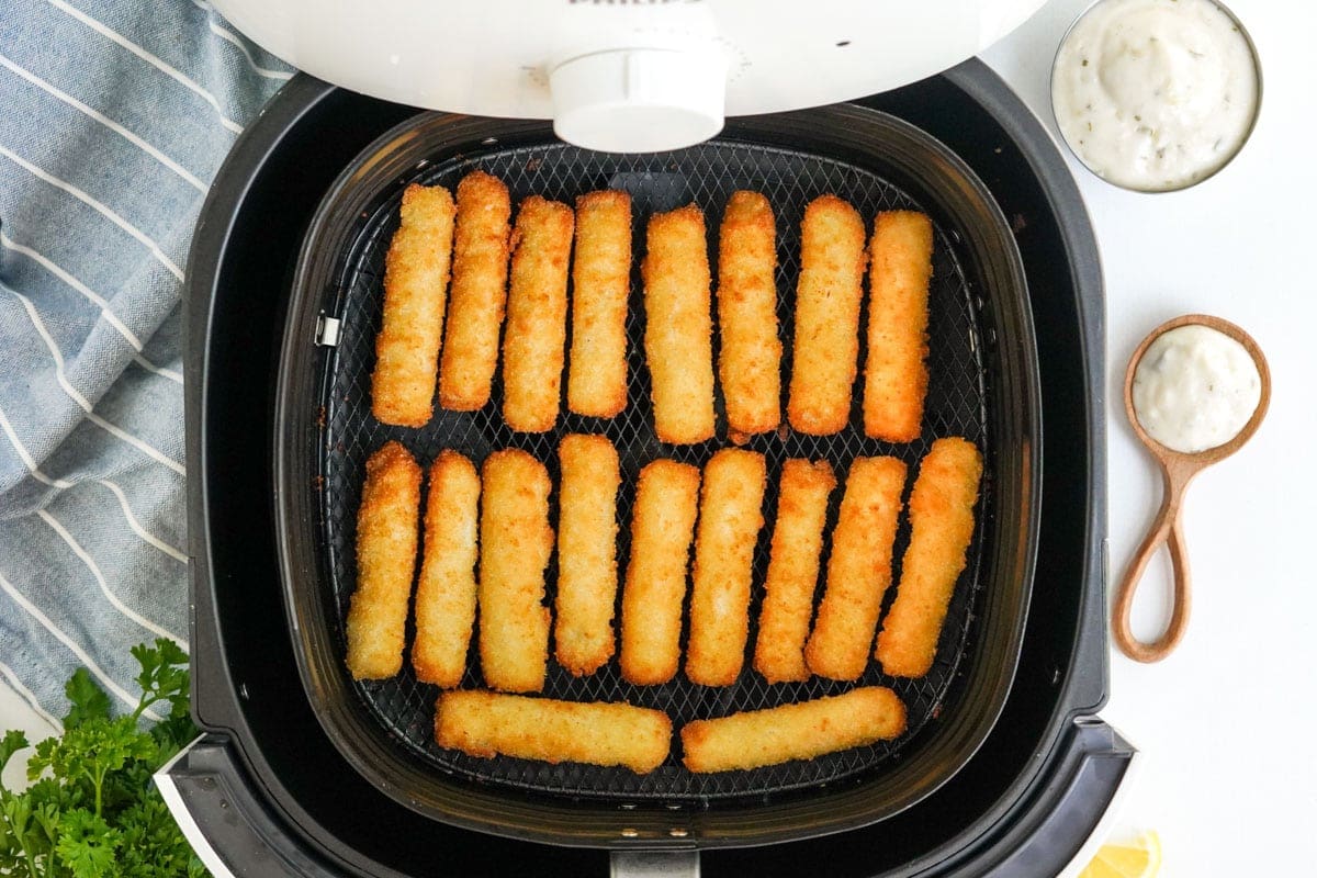crispy crunchy fish sticks cooked in an air fryer basket