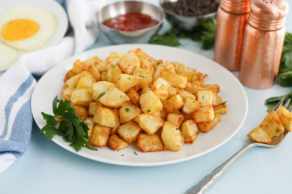 crispy air fryer home fries on a white plate