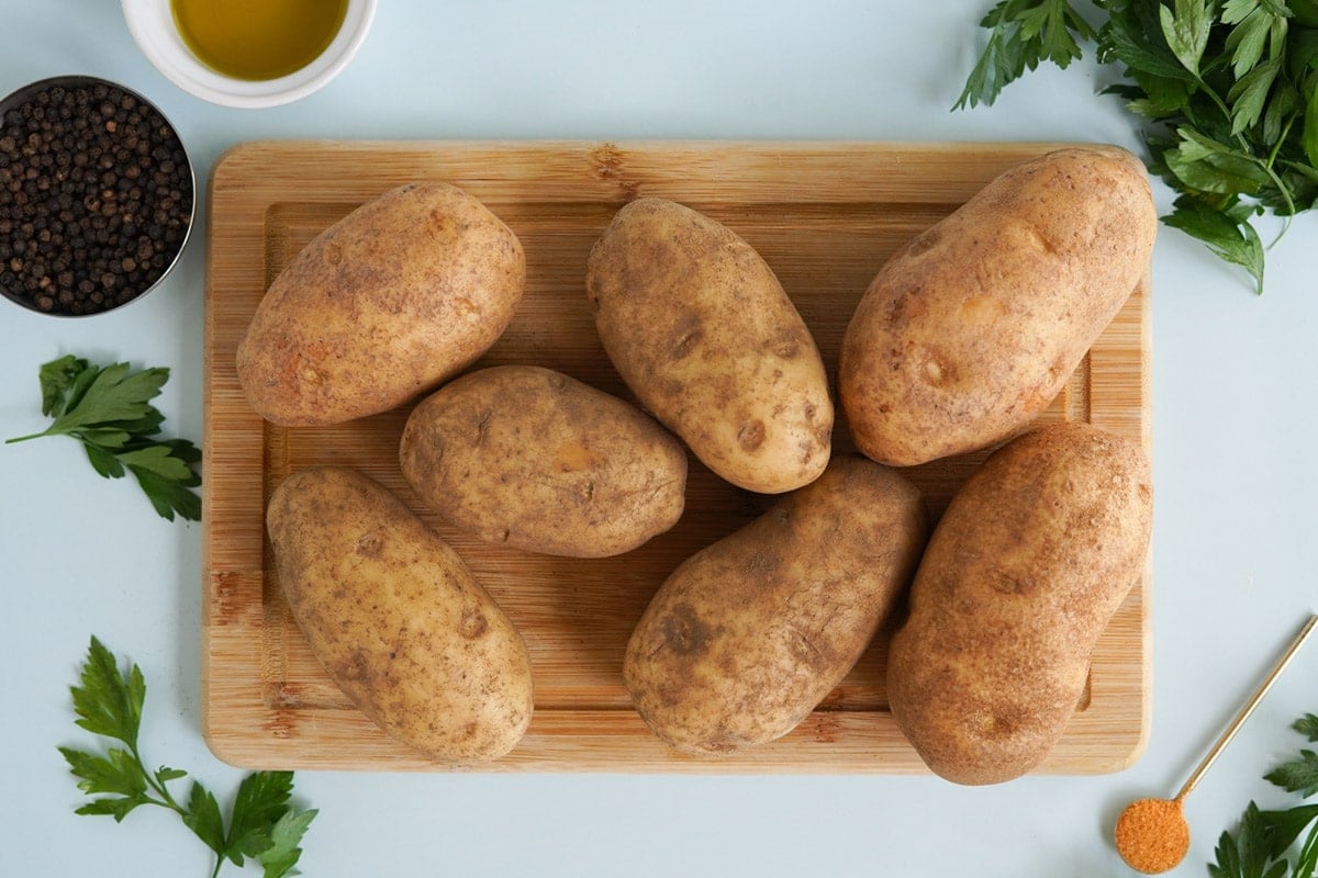 russet potatoes on a cutting board