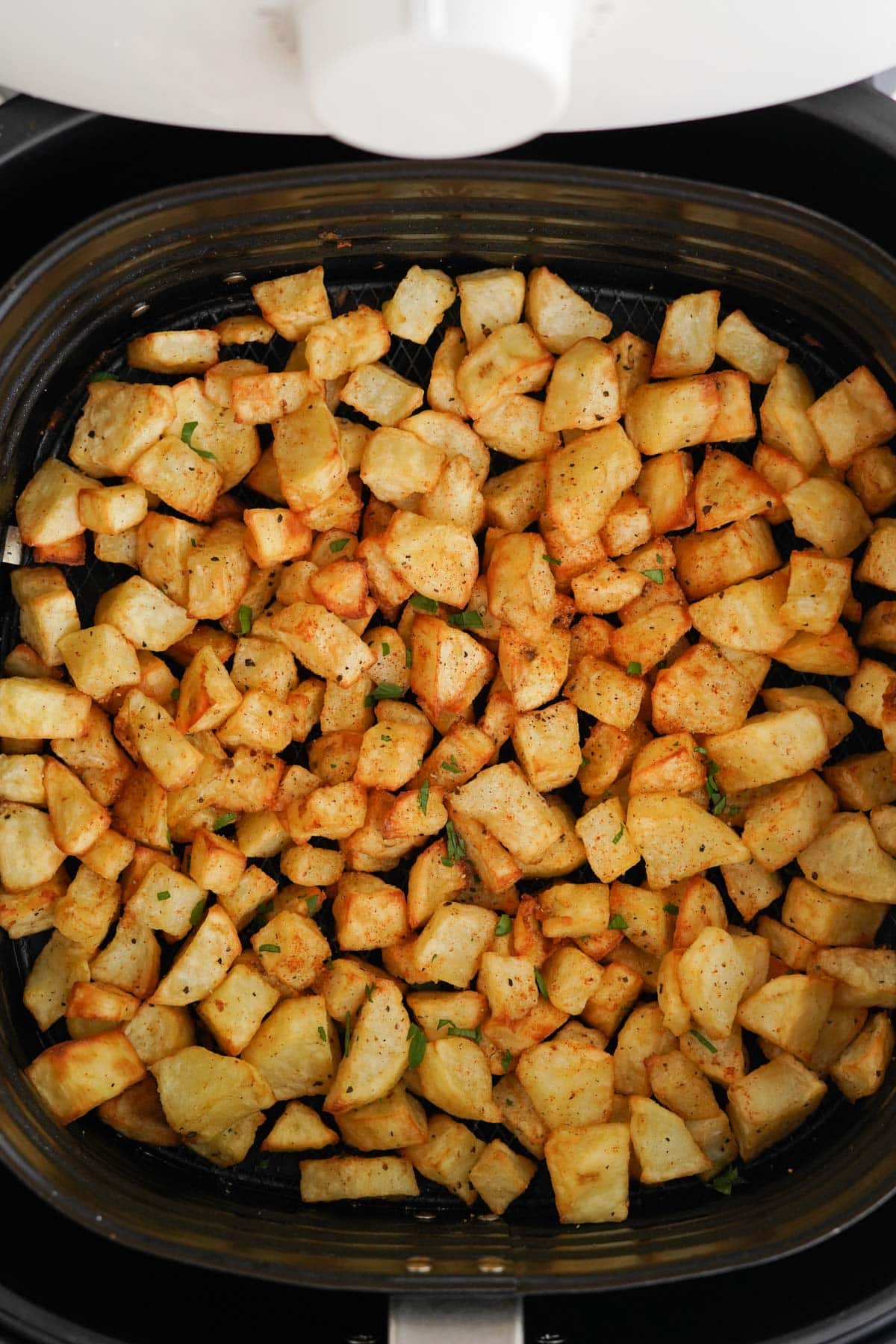 crispy home fries in an air fryer basket