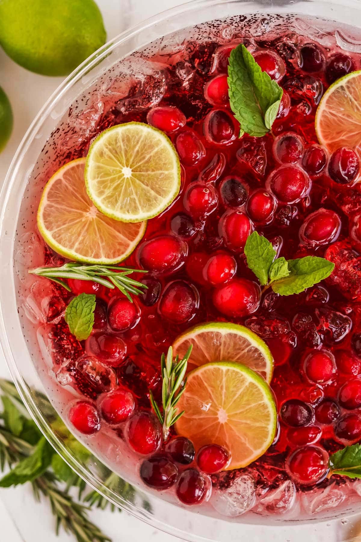 champagne punch with cranberries, lime, mint and rosemary