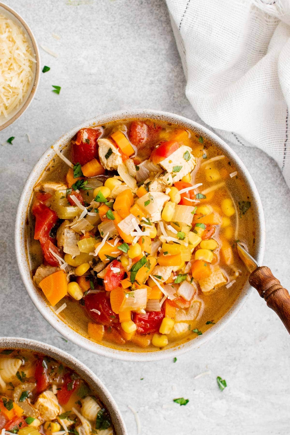 chicken vegetable soup in a white bowl