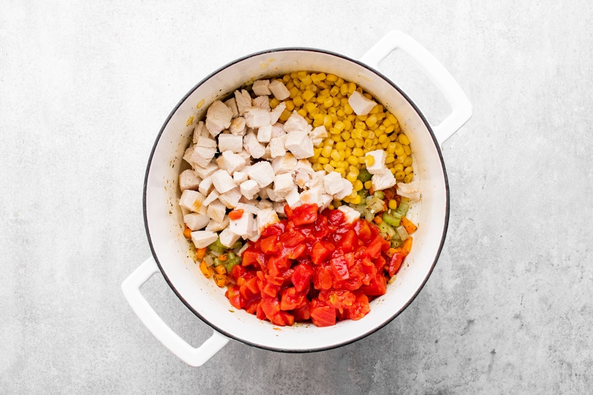 chicken corn tomatoes in white pot