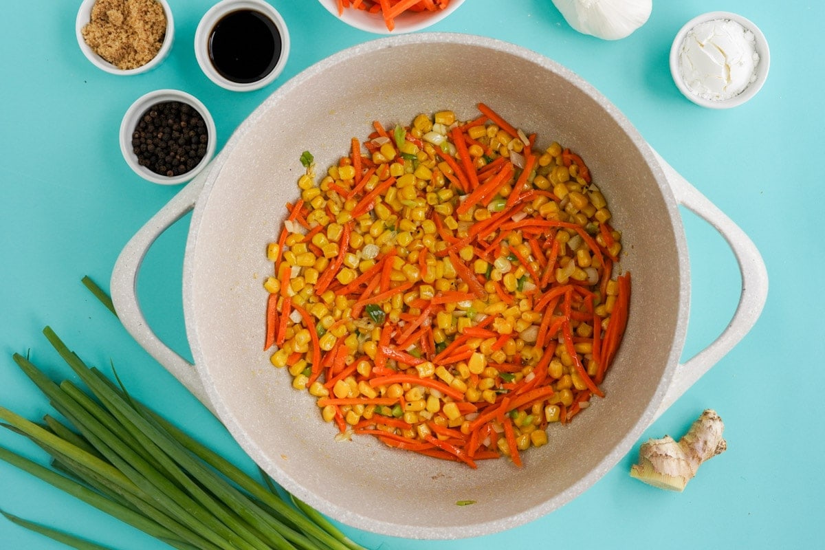carrots, corn, onions in a large pot