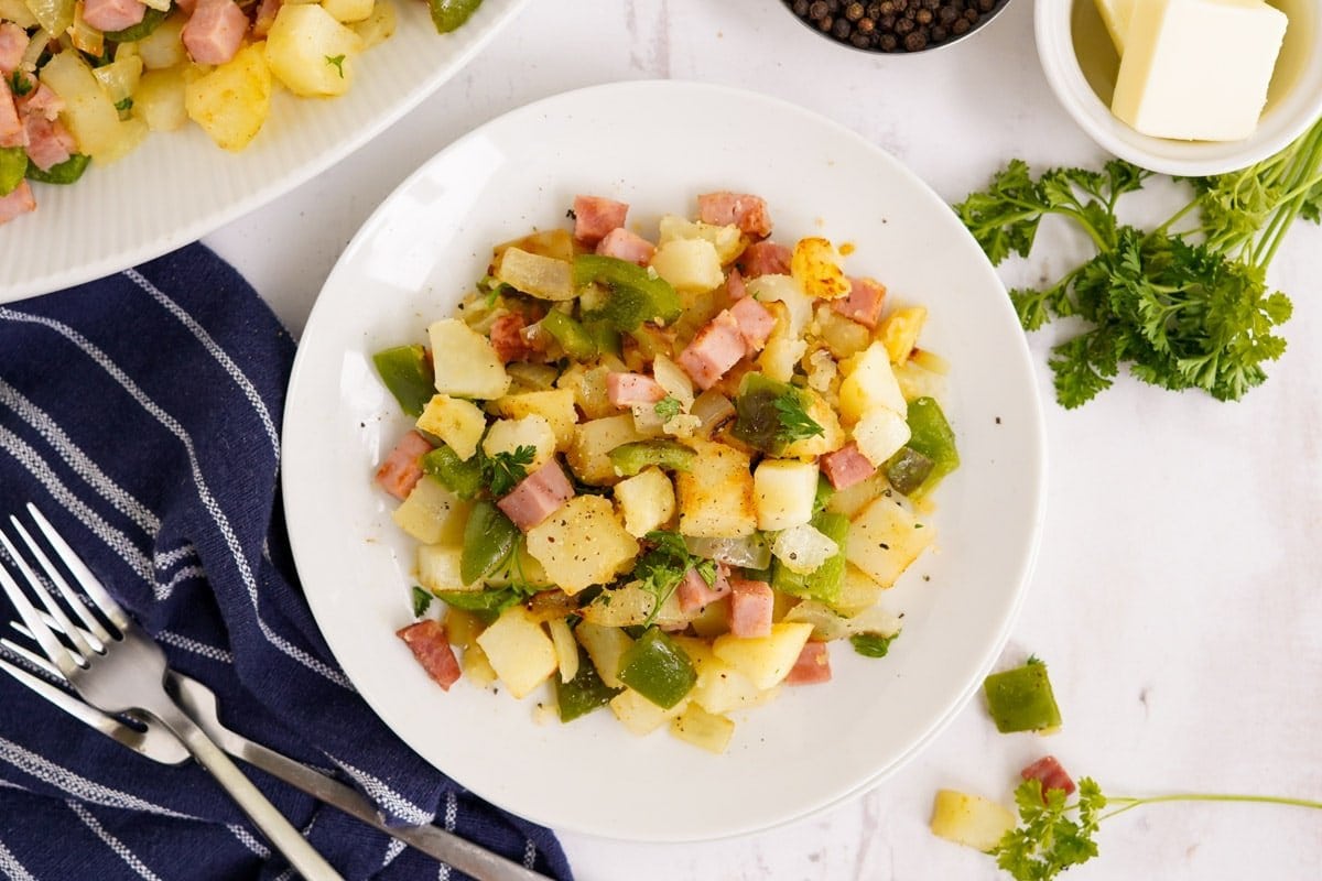 ham and potato hash on a white plate