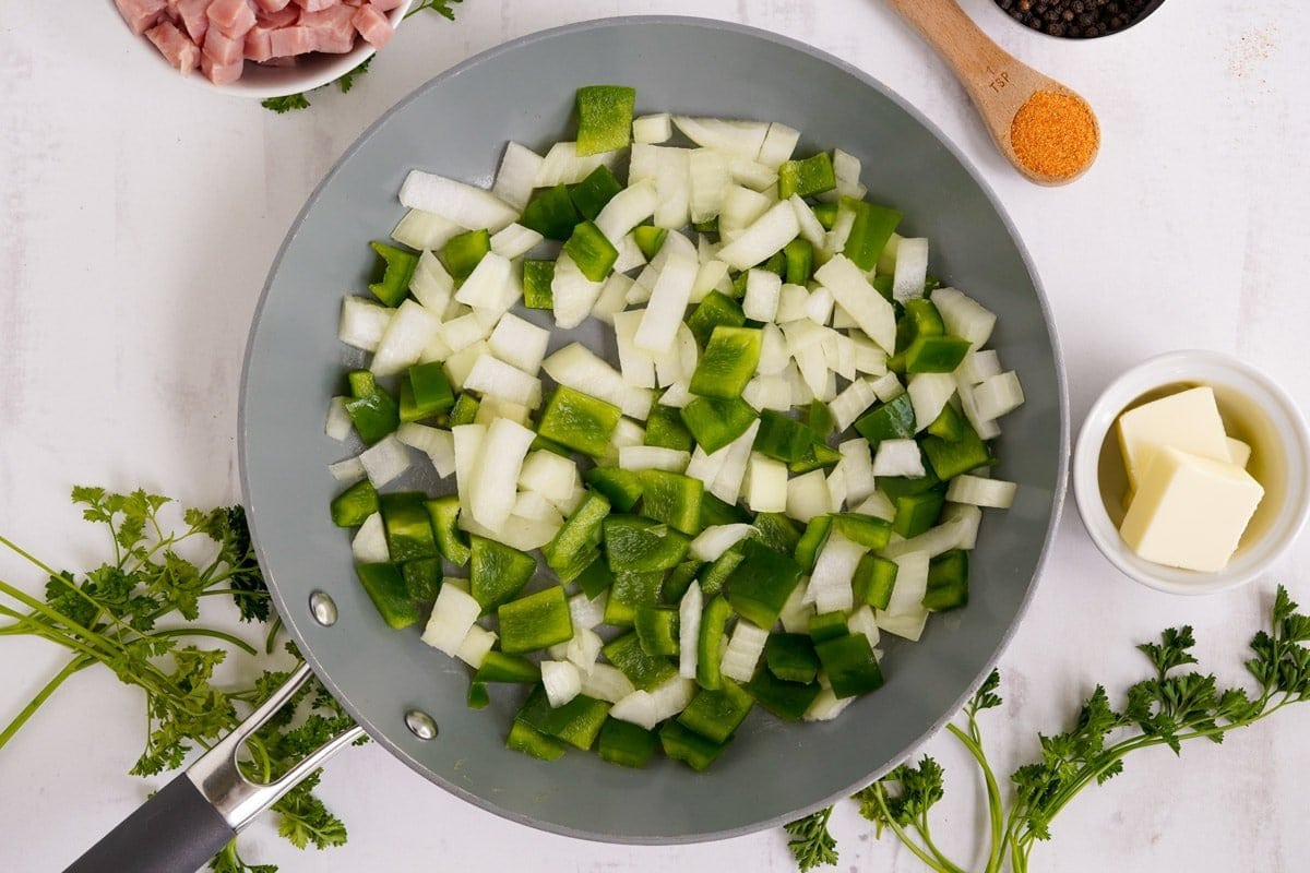 green bell peppers and onions in a skillet