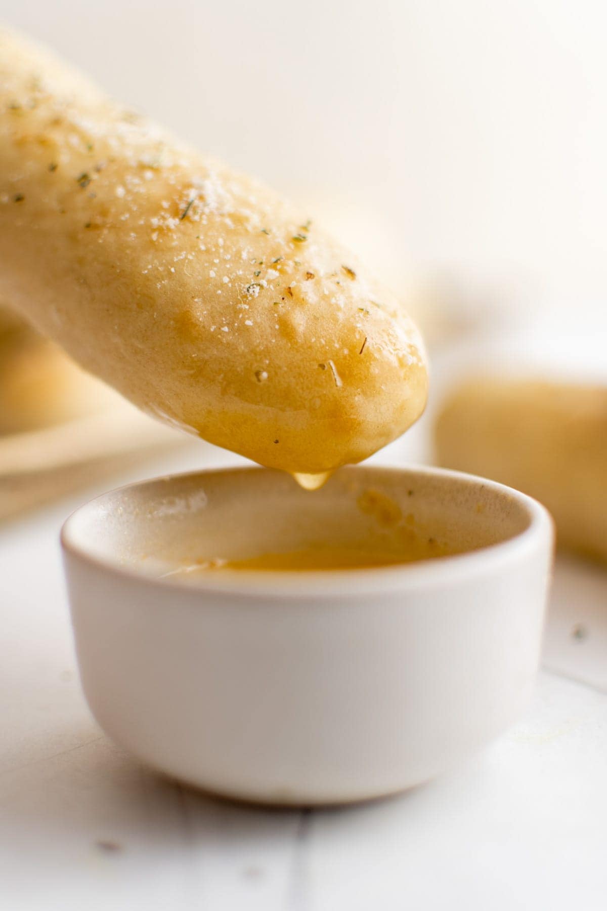homemade breadstick dipped in melted garlic butter