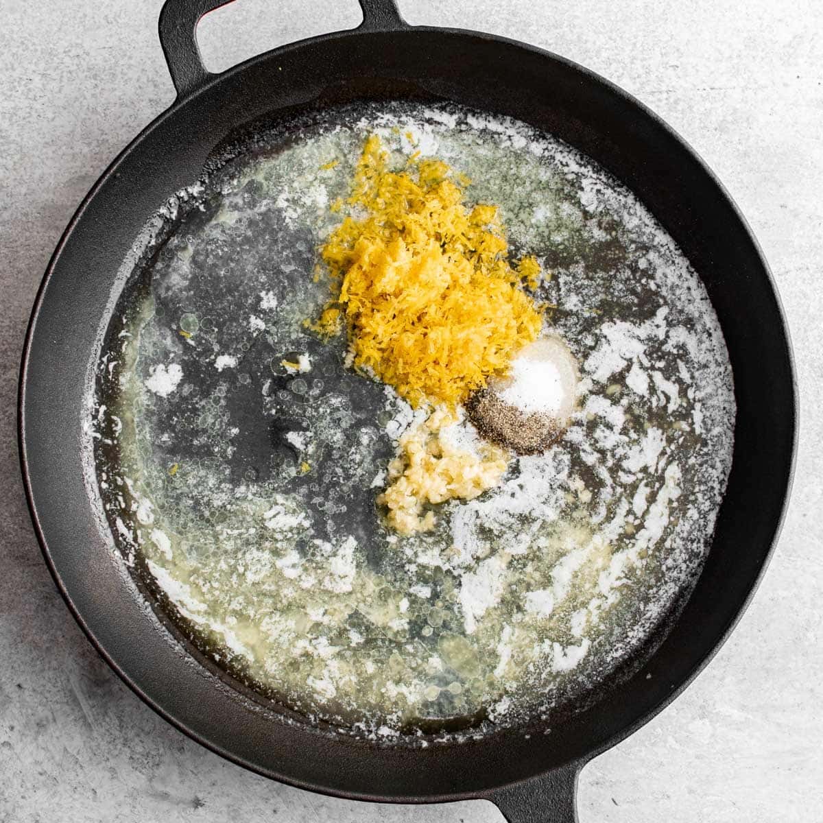 lemon zest, juice and garlic with butter in a skillet