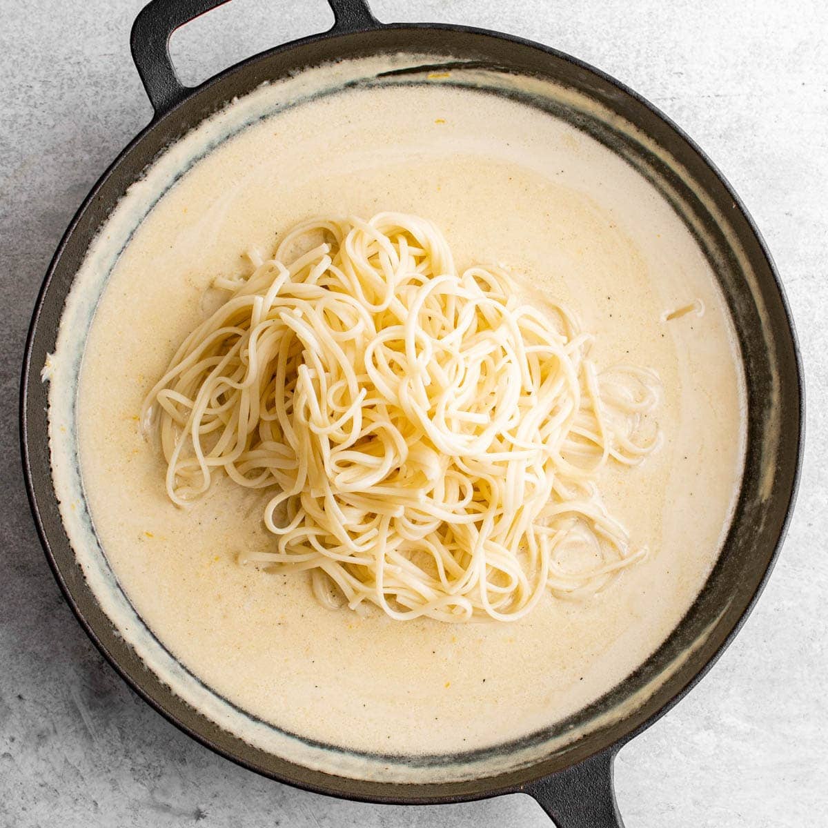 lemon butter sauce and pasta in a skillet