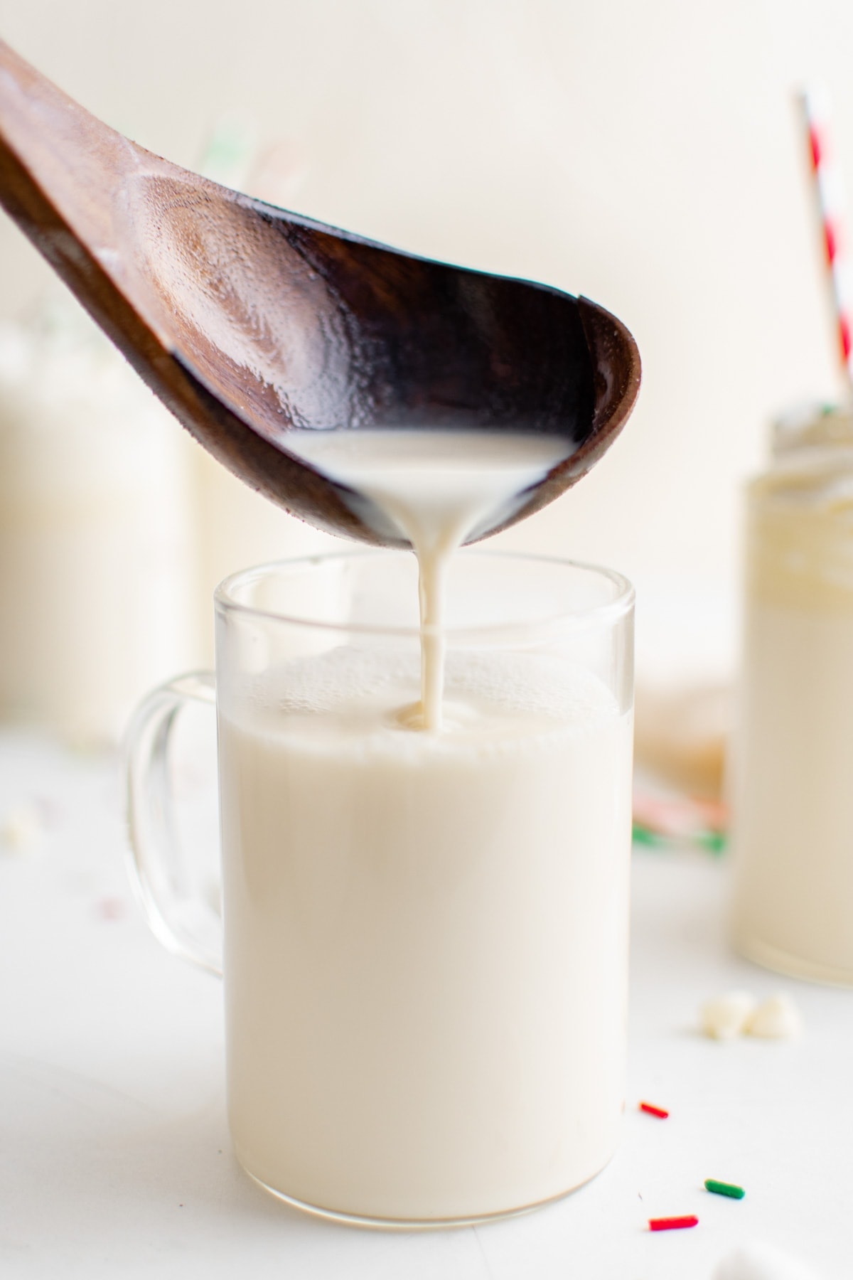 ladle pouring white hot chocolate into a mug