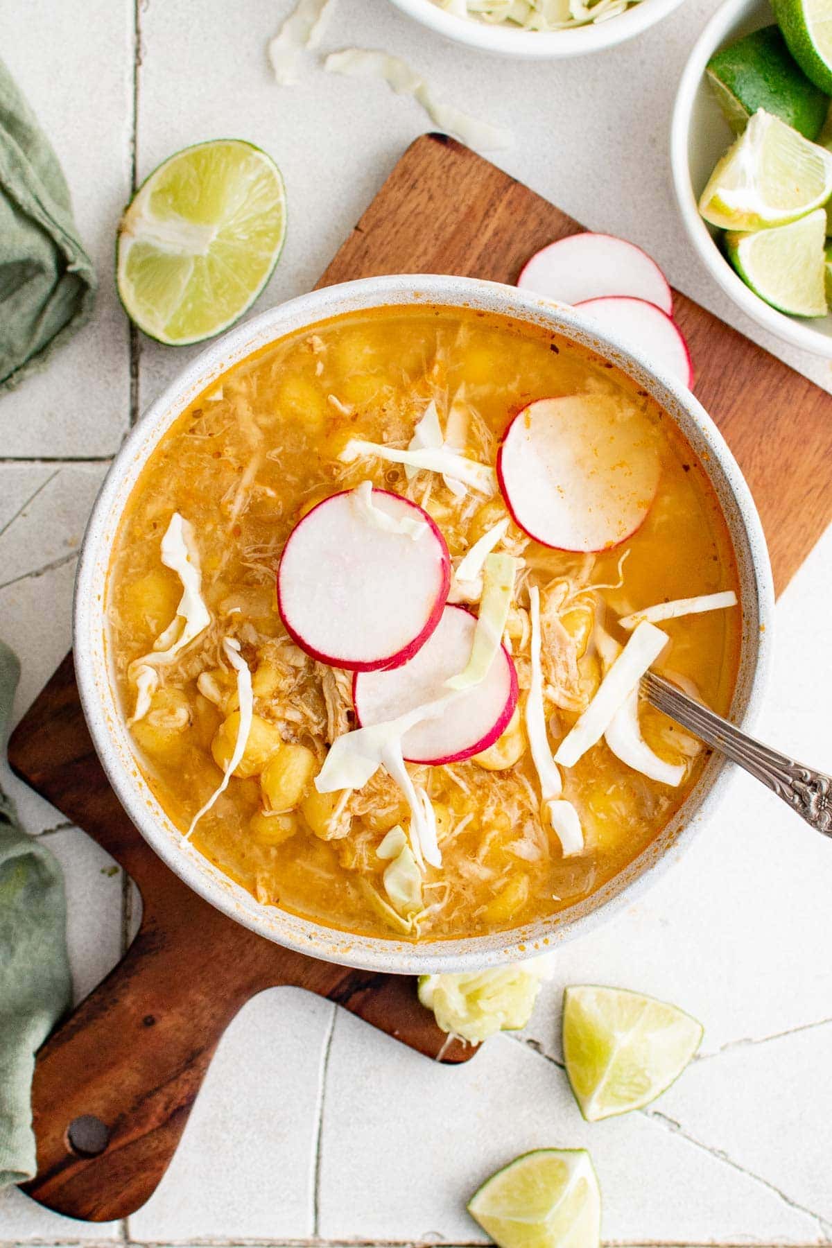 overhead shot of red chicken pozole sou topped with cabbage and radishes
