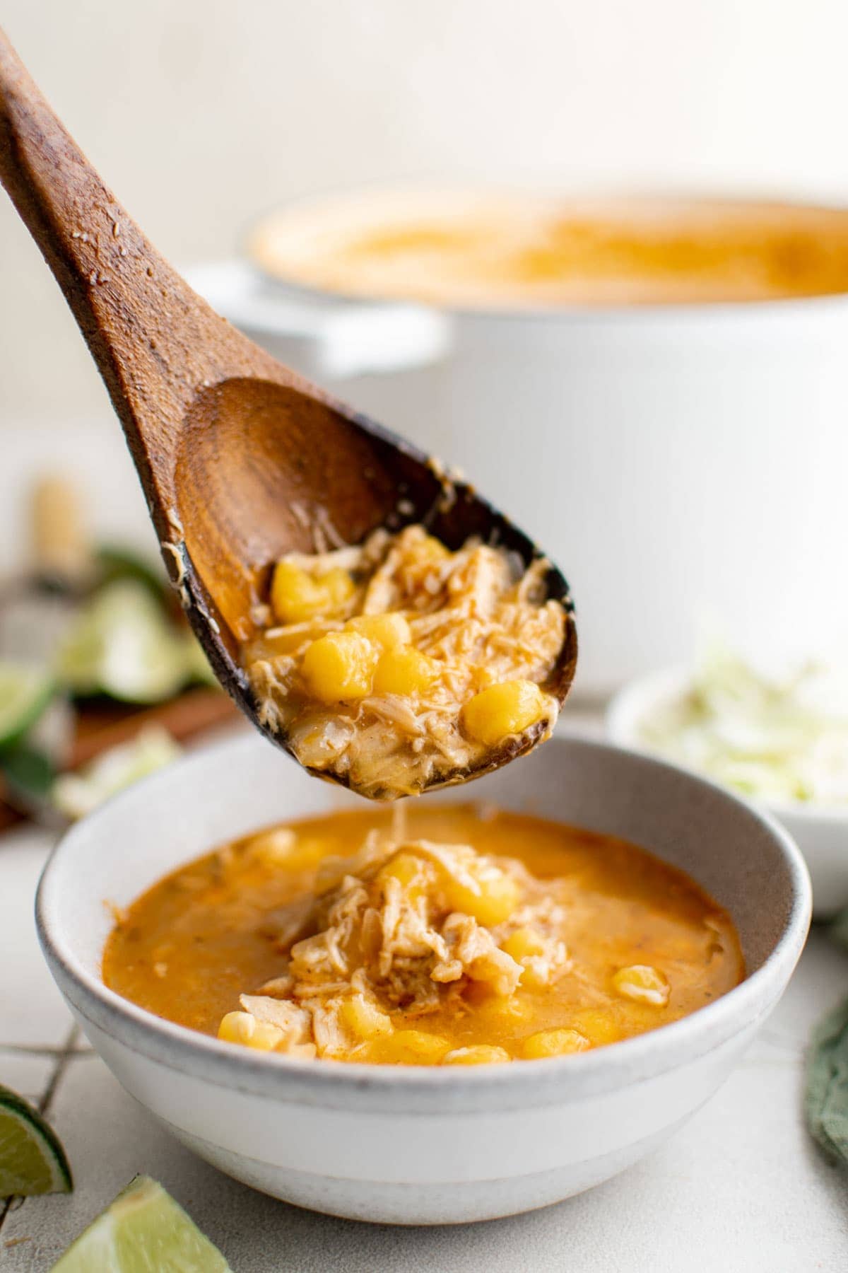 wooden ladle and bowl of red chicken pozole