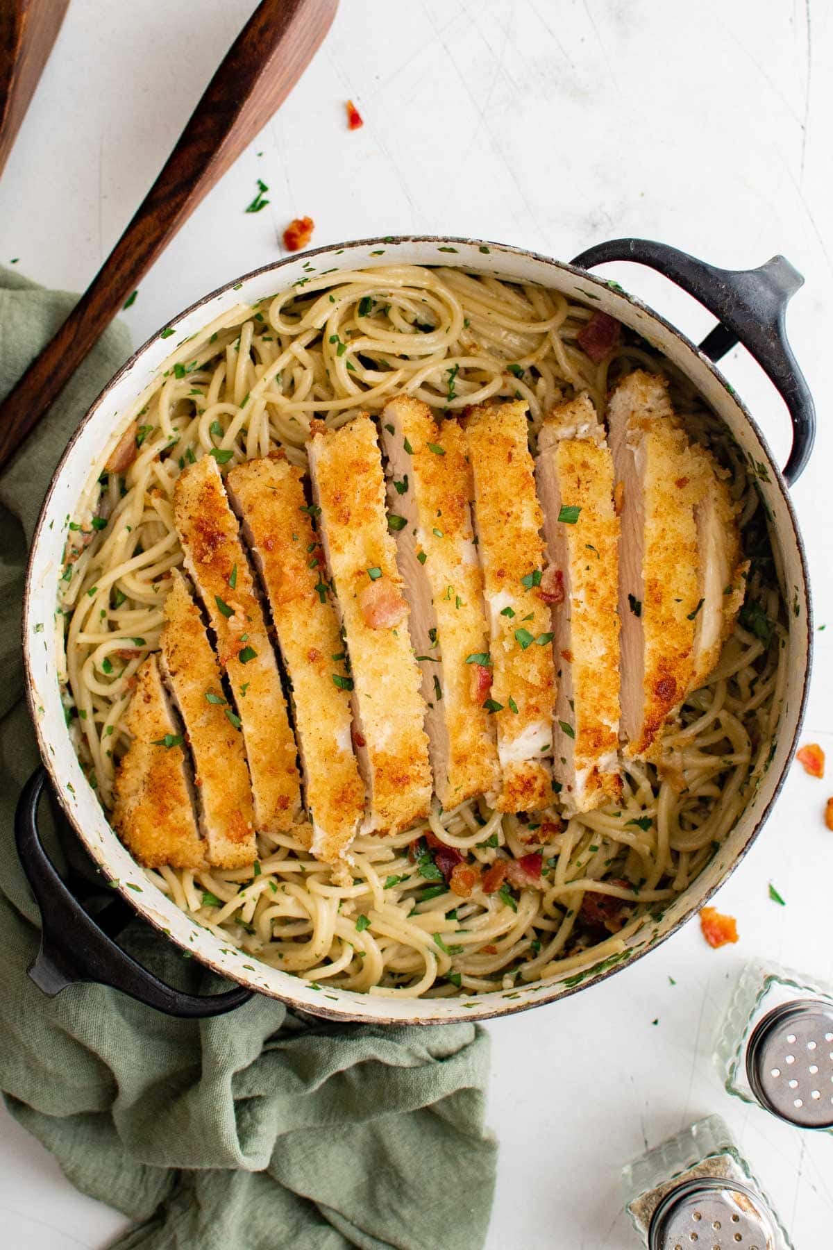 crispy chicken breast on a bed of noodles with carbonara sauce