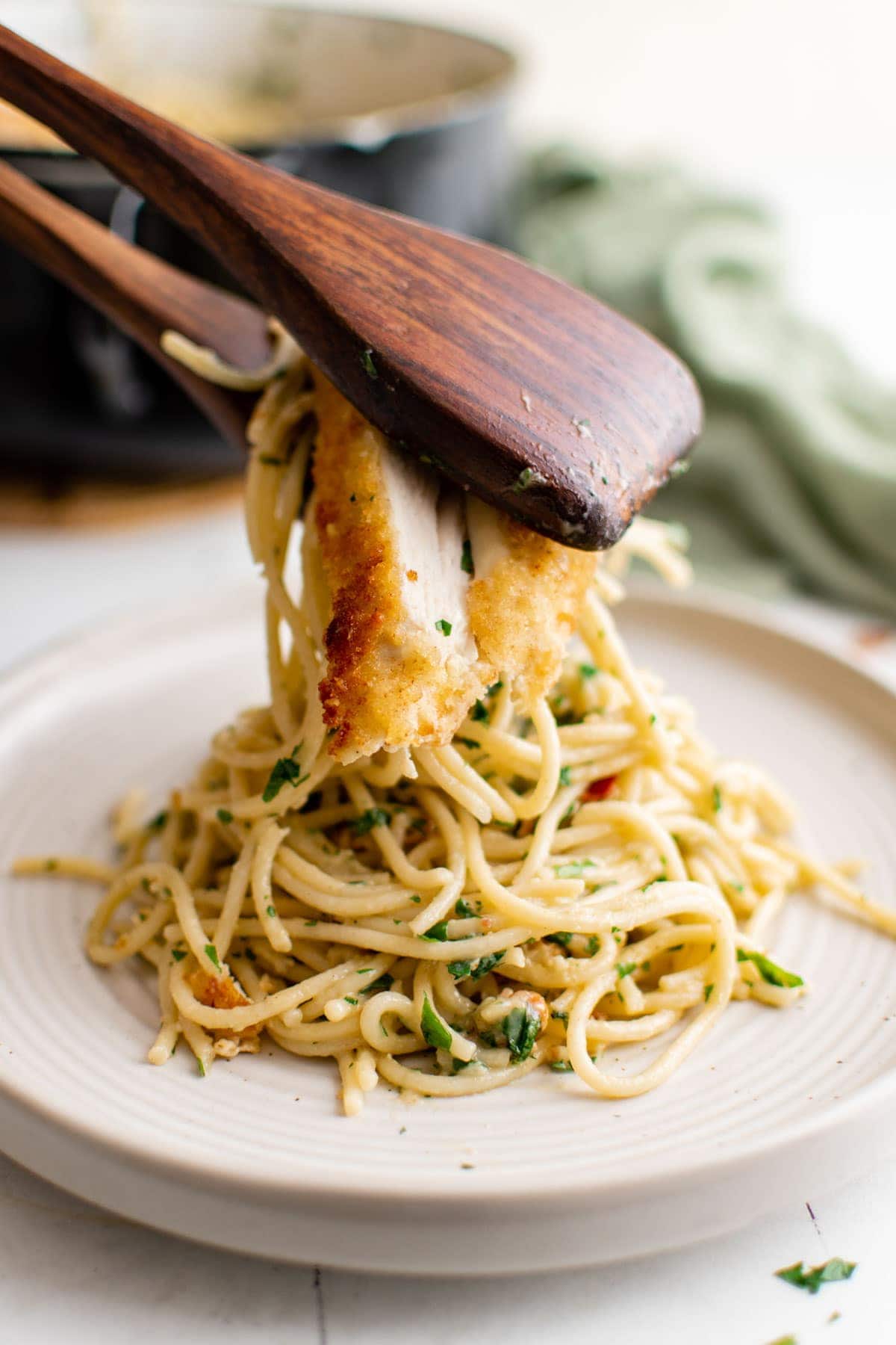 chicken carbonara , white plates, wood tongs