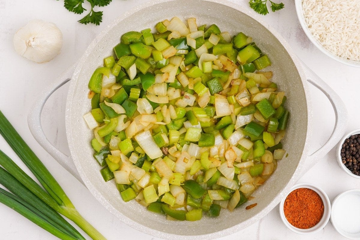 green peppers, onions and celery in a pot