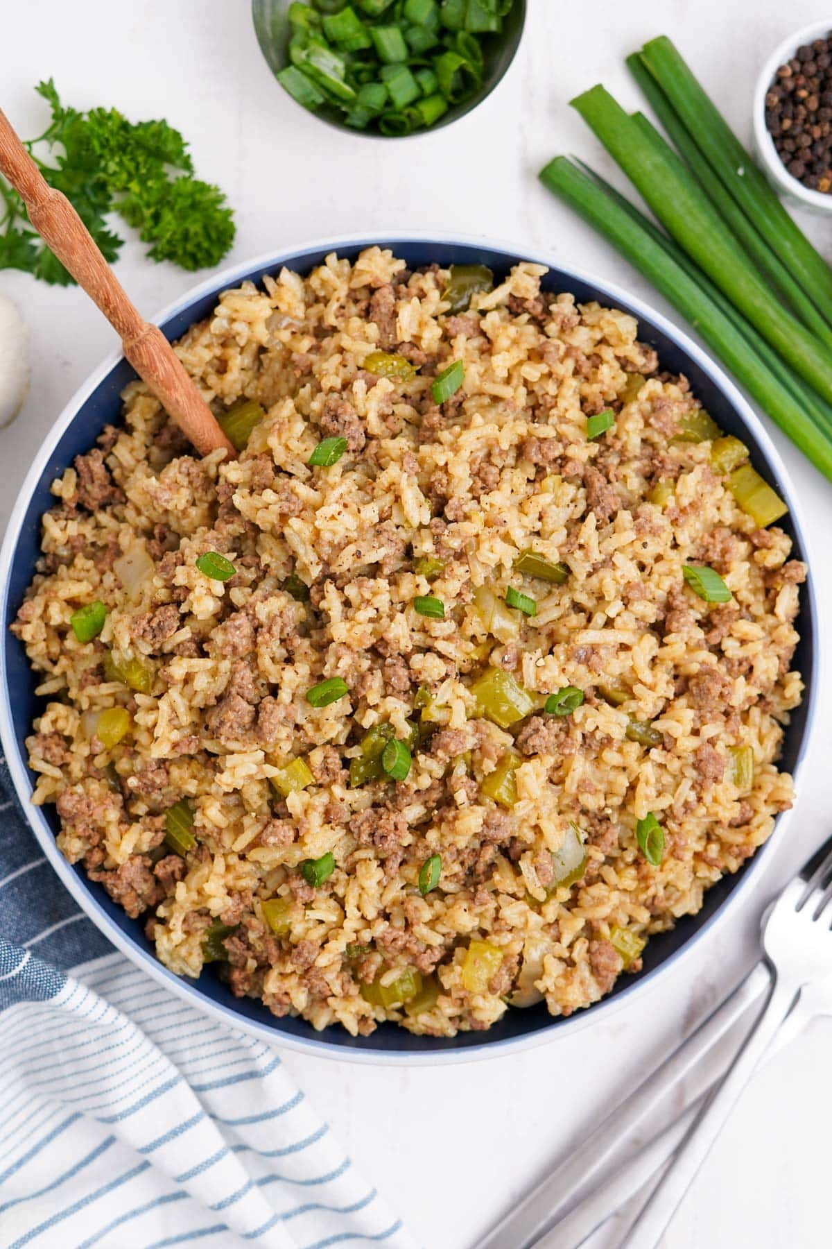 dirty rice with ground beef and a wooden spoon