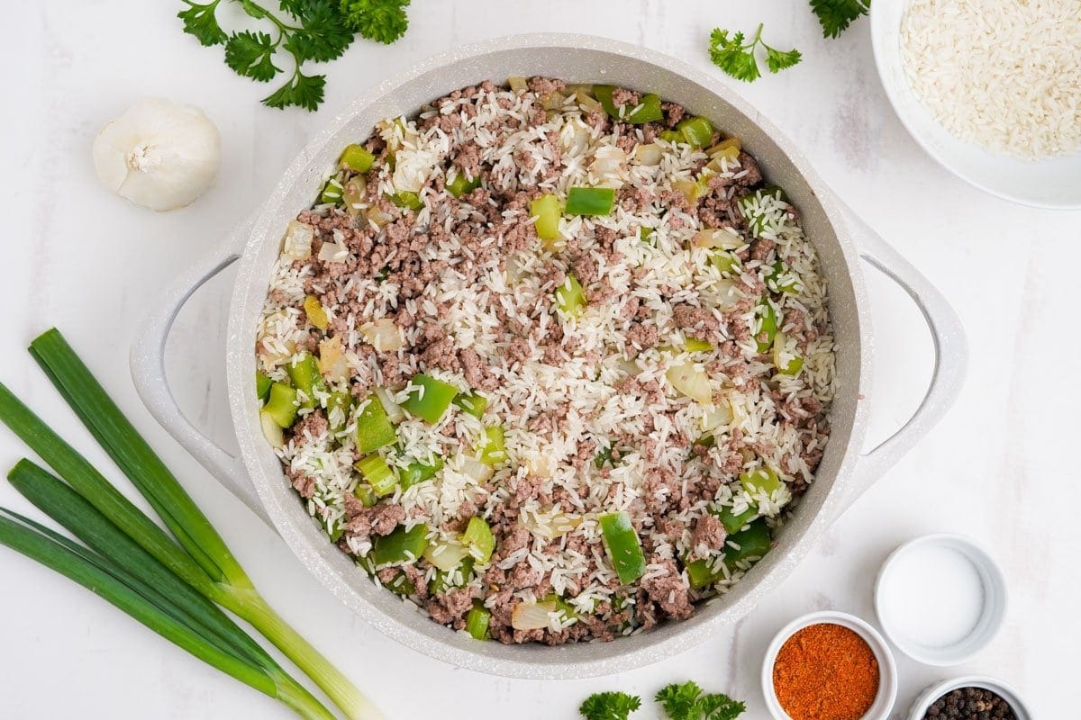 rice, ground beef and vegetables in a white pot