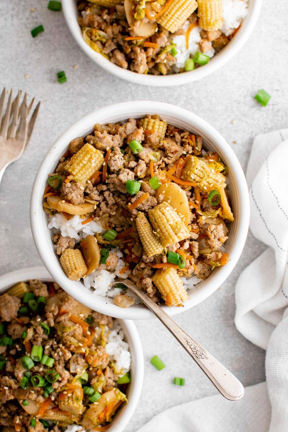 ground pork stir fry with veggies over rice in bowls