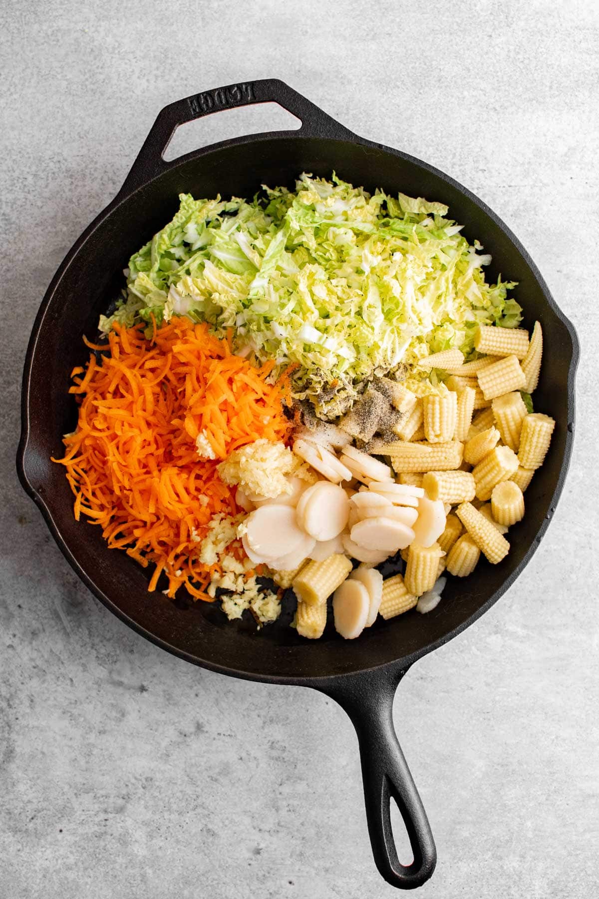 shredded carrots, cabbage, baby corn, water chestnuts in a large skillet