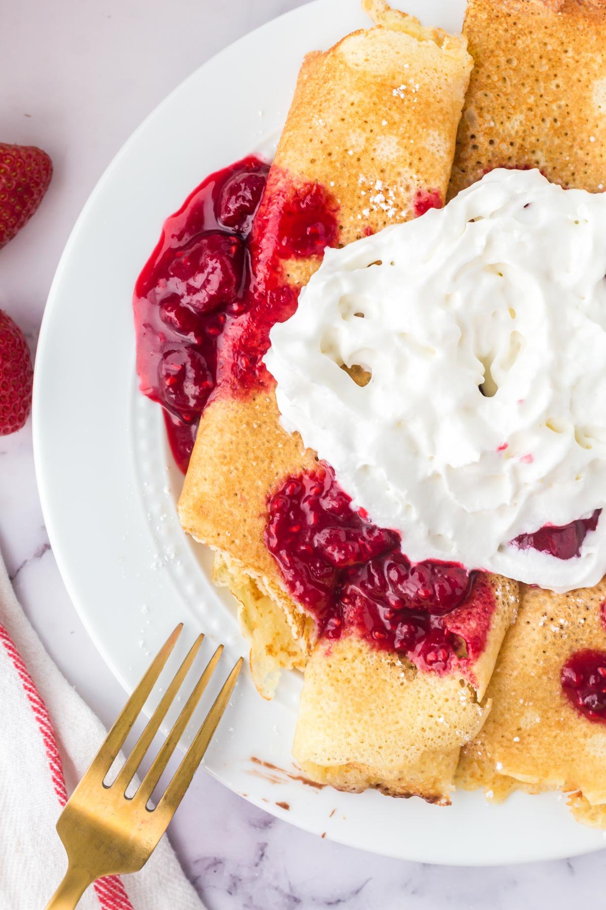 swedish pancaked with berries and whipped cream