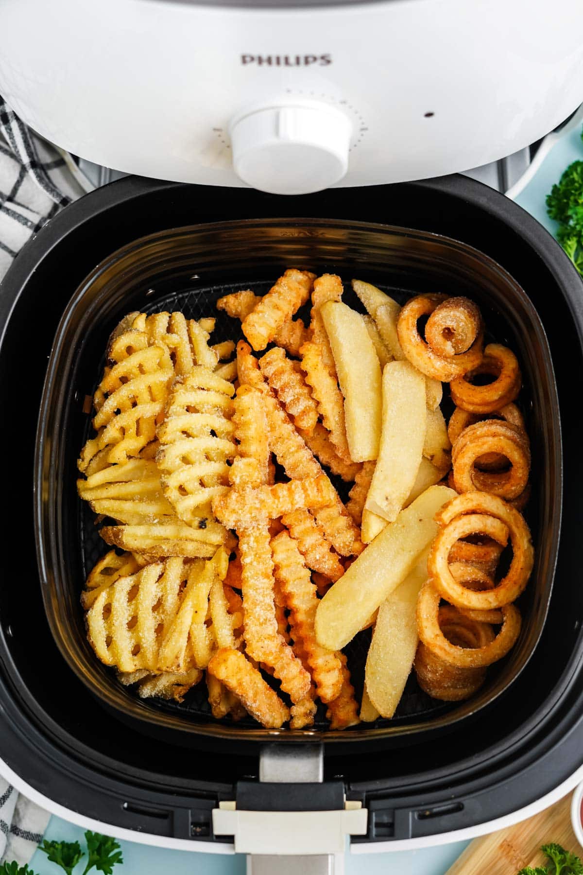 air fryer basket with frozen french fries