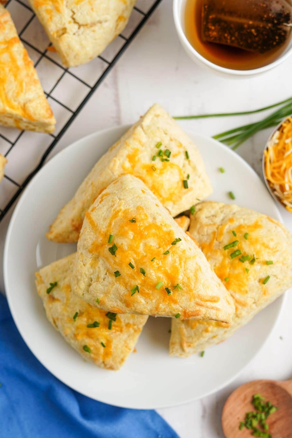 cheese scones with chives on a white plate