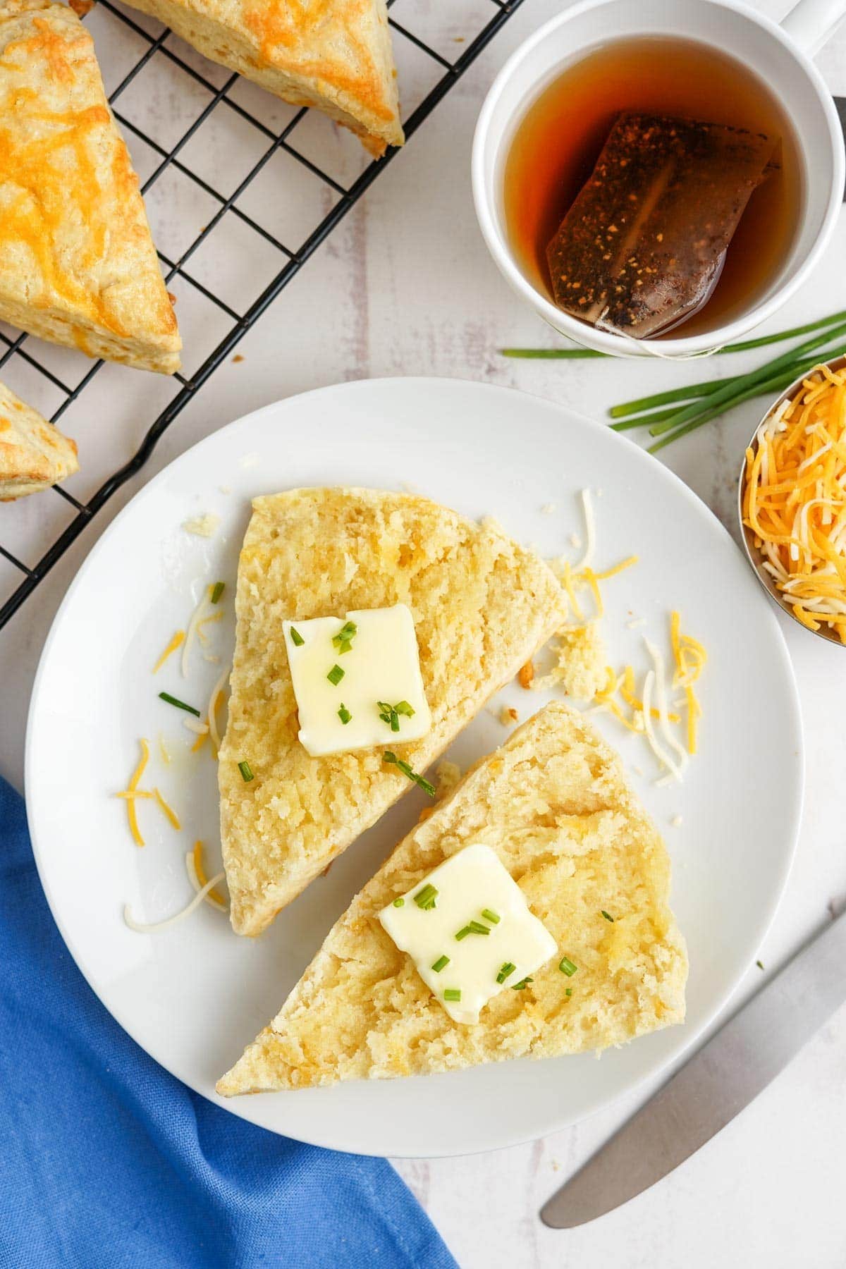 scone split in half with butter and chives