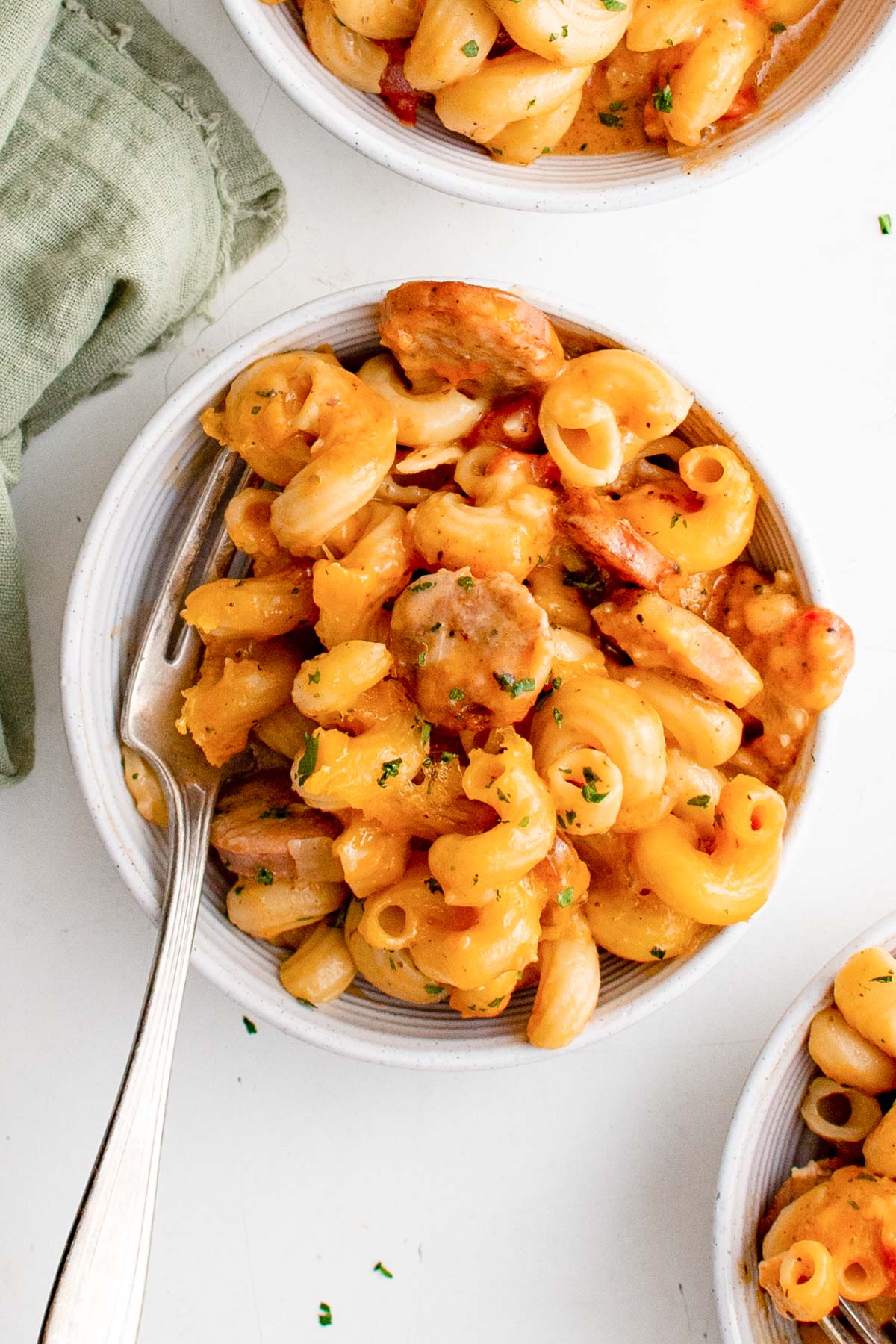 pasta, cheese and sausage mac and cheese in a bowl