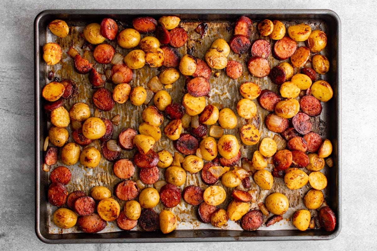 cooked sausage and potatoes on a sheet pan