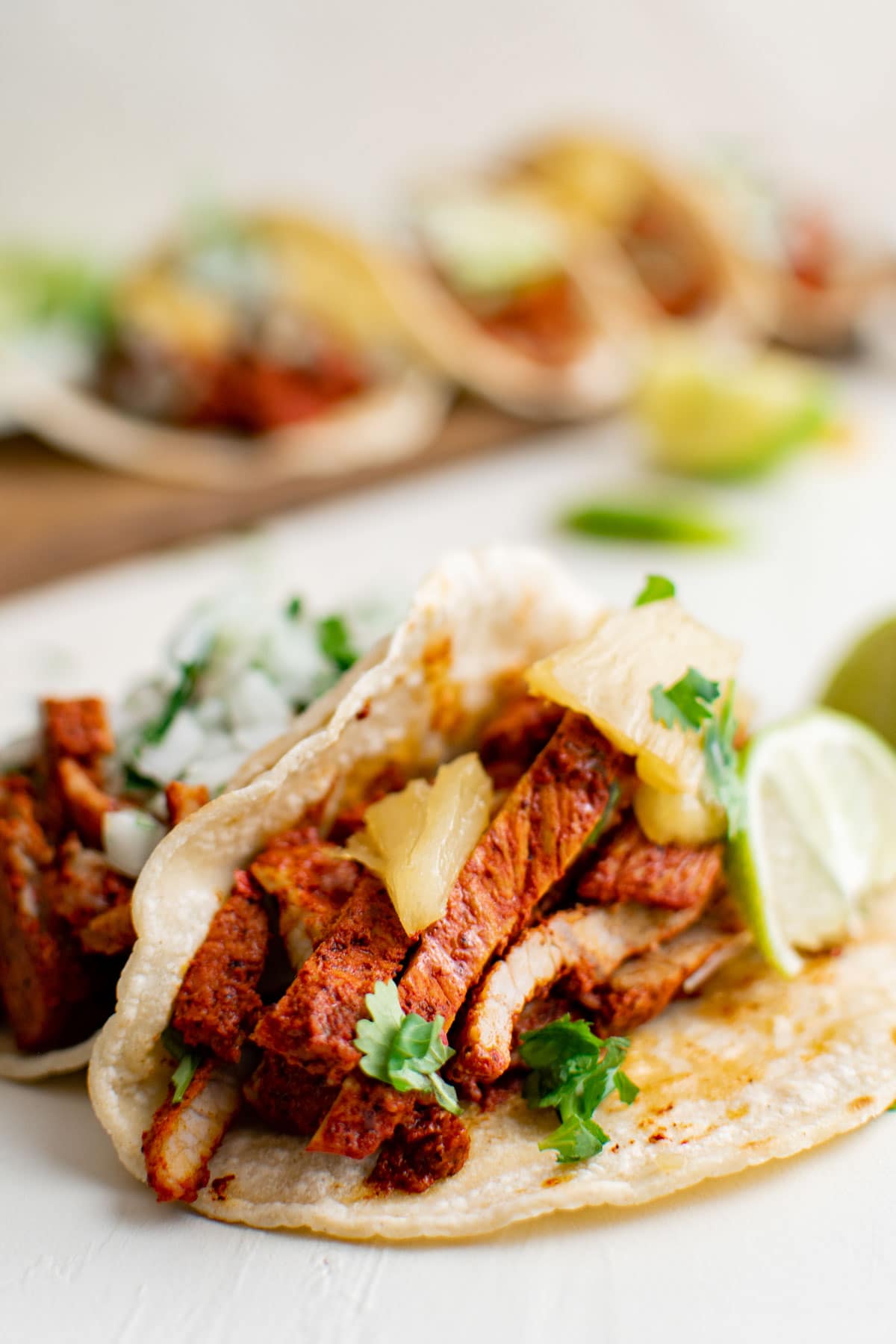 Tacos al pastor with pineapple onions and cilantro. 