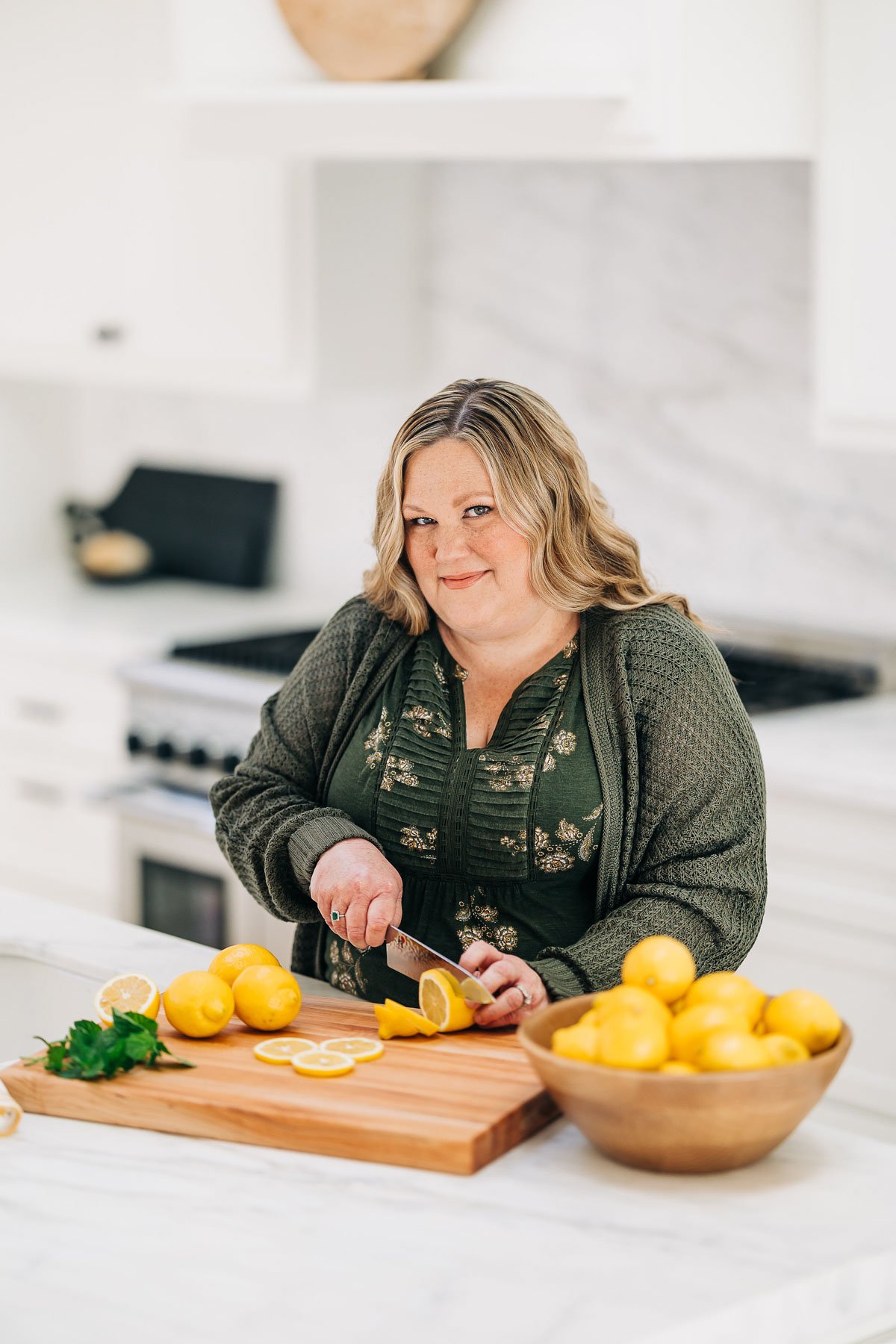 woman chopping lemons on a cutting board