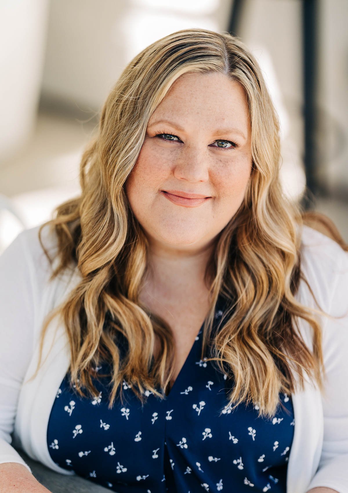 image of a smiling woman in a blue shirt