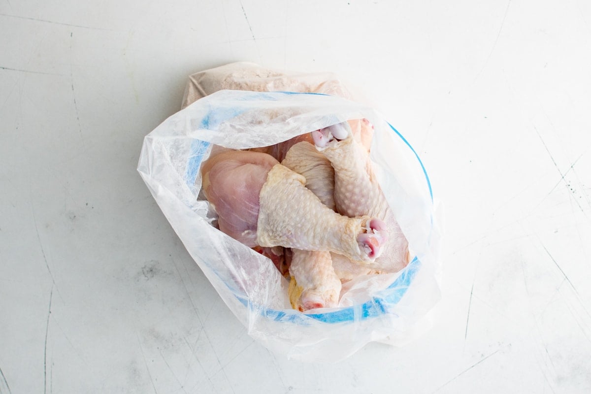 Chicken drumsticks in a plastic bag.
