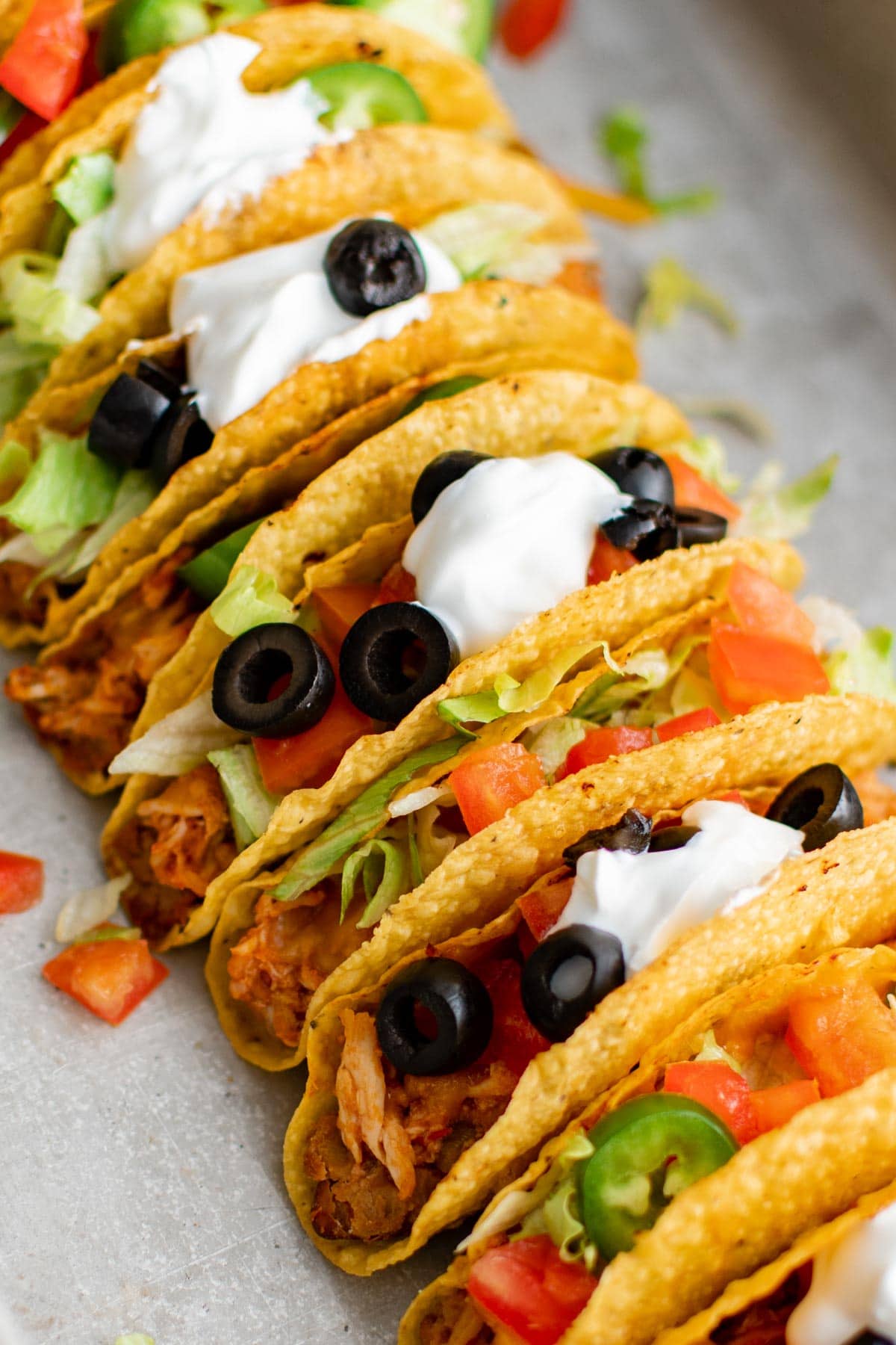 baked chicken tacos in a line