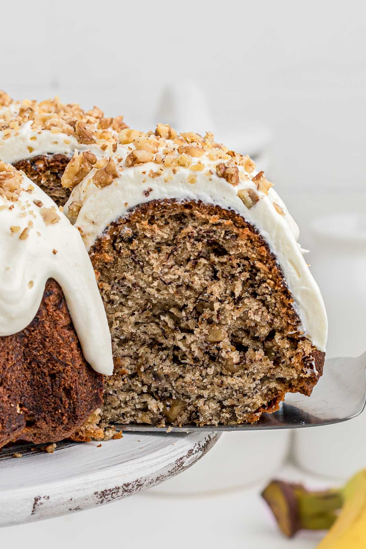 banana bundt cake with a slice removed, exposing the inside
