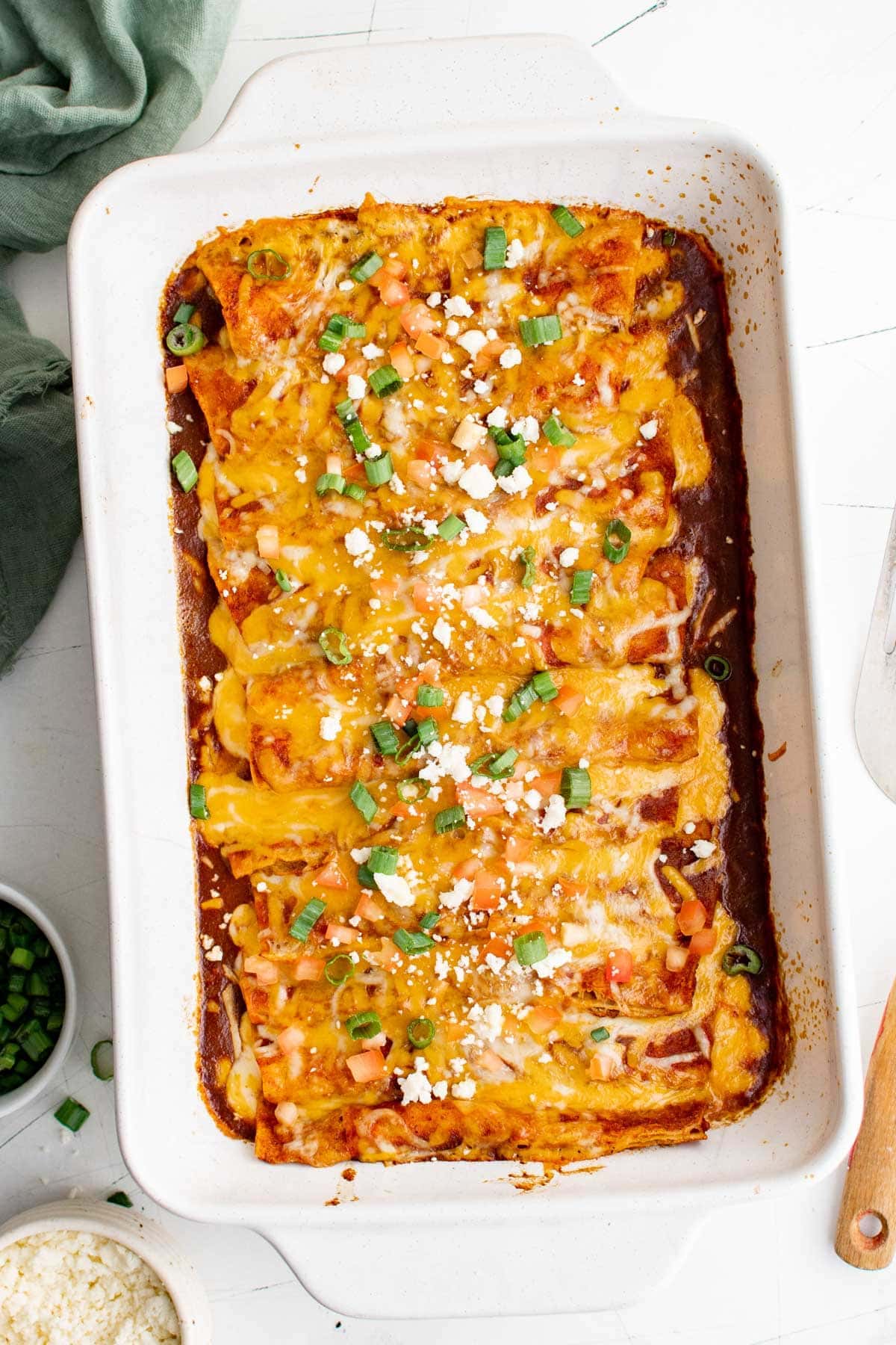 white baking dish with a batch of cheese enchiladas