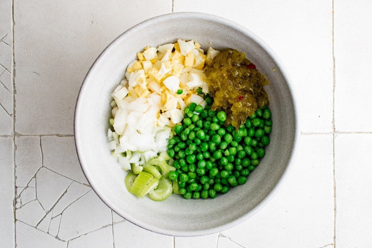 macaroni, peas, celery onions pickle relish in a bowl