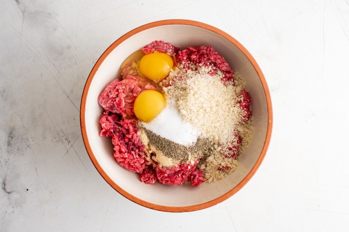 ground beef, eggs, parmesan cheese, breadcrumbs, seasoning in a bowl