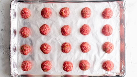 uncooked meatballs on a tray