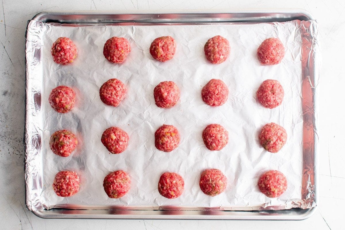 uncooked meatballs on a tray