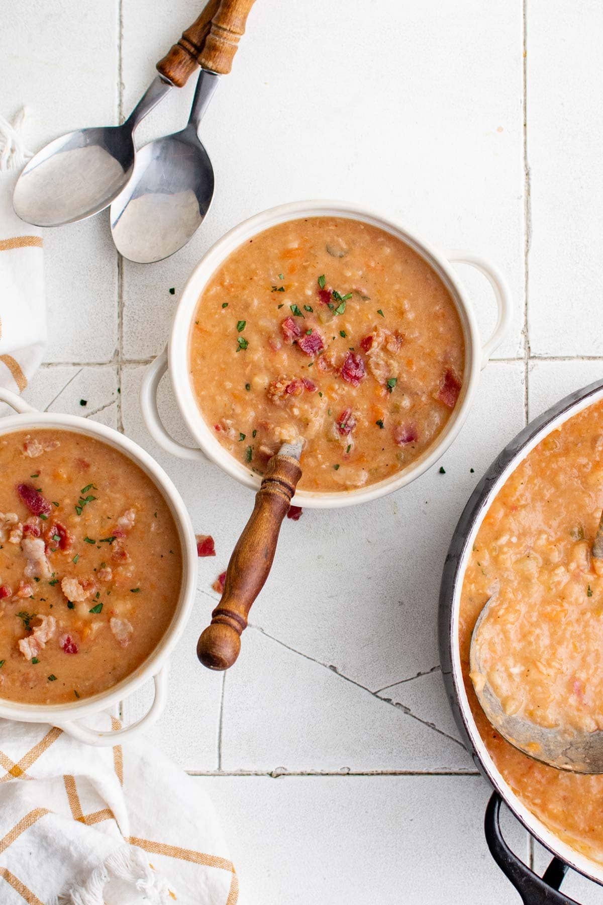 3 bowls with bean soup and spoons