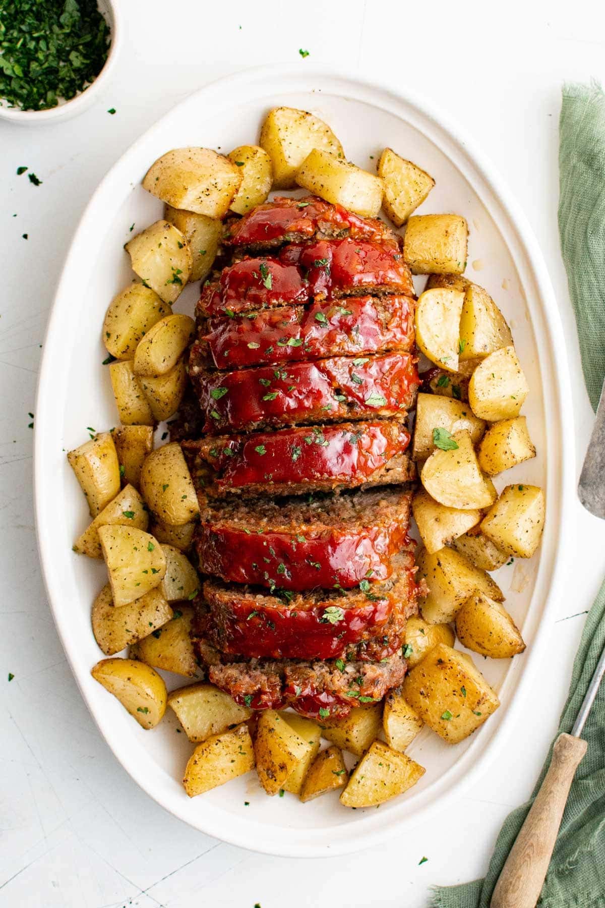 sliced meatloaf and potatoes on a large platter