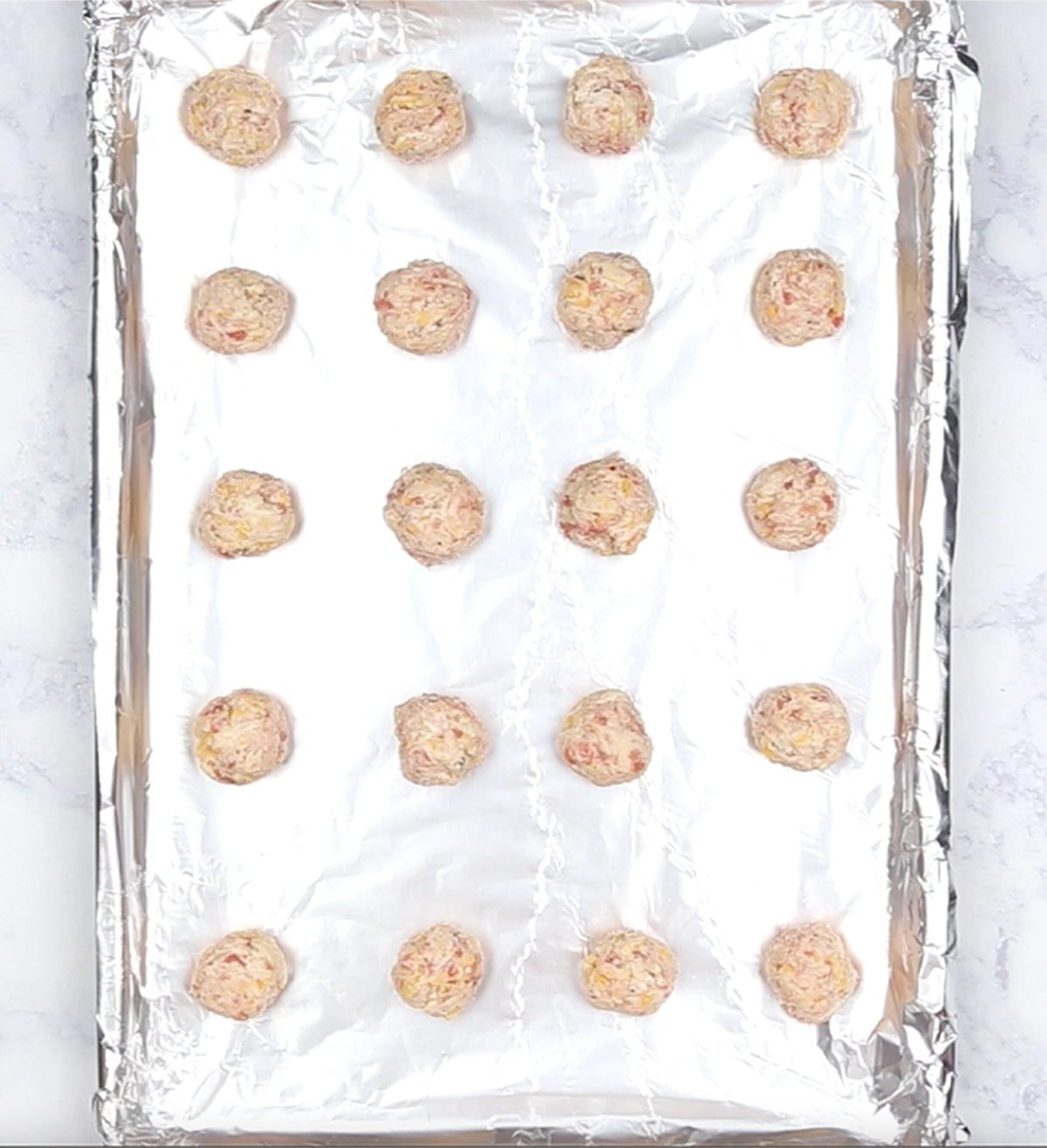 sheet tray with uncooked sausage balls