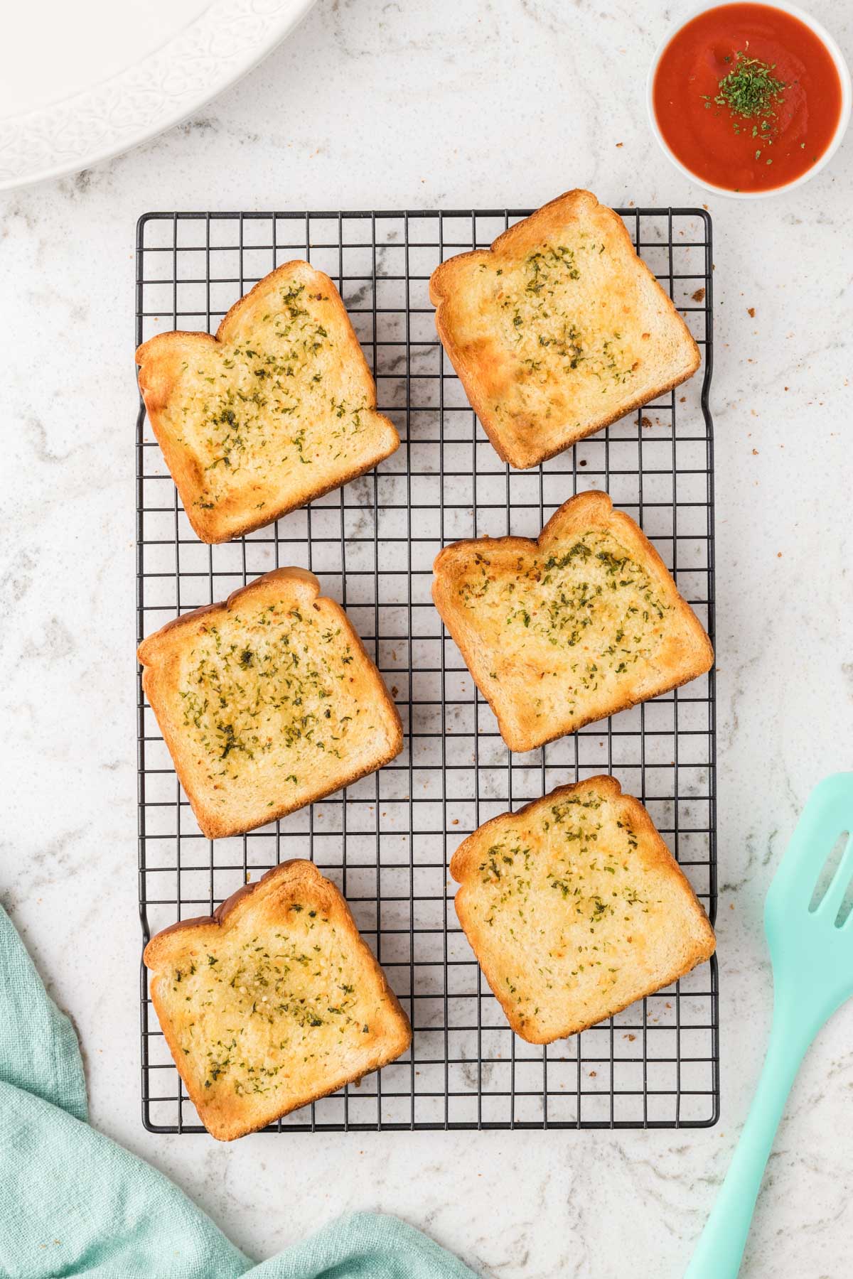 Garlic bread texas toast on a wire rack.