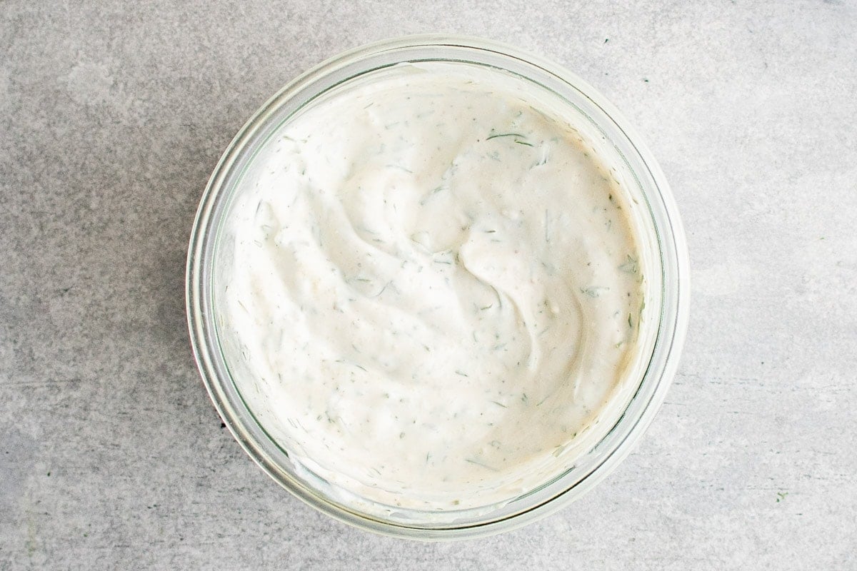 Dill sauce in a clear glass bowl. 